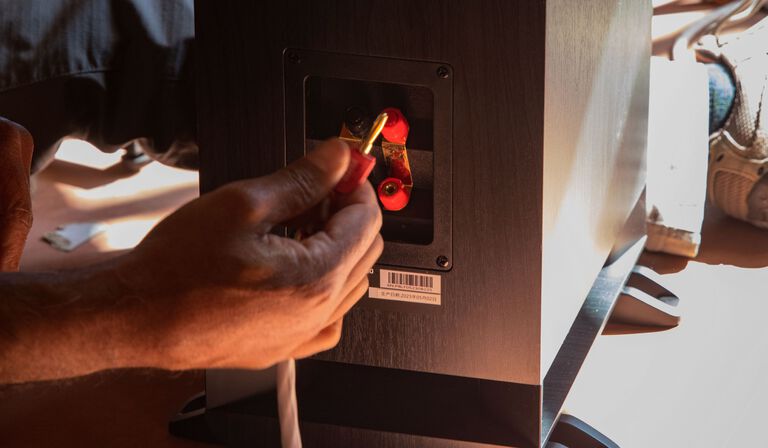 A couple dancing with music from a sound bar.